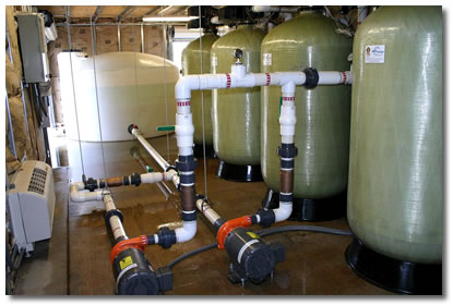 Industrial water filtration equipment installed at the Winrock Corporate Headquarters.  In the picture you can see the carbon filter tanks, pumps, and water retention tanks.  
